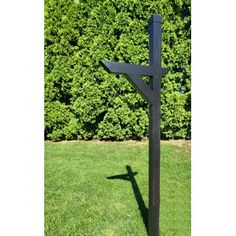 a black metal cross is in the grass