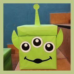 a green box with eyes and a mustache on it