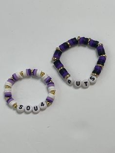 two purple and white bracelets with words that spell out the word squat on them