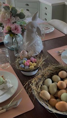 an easter table setting with eggs and flowers