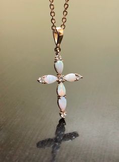 DeKara Designs Collection Metal- 14K Rose Gold .585 Stone- 5 Genuine Australian Pear Shape Opals, 5 Round Diamonds G Color VS2 Clarity 0.15 Carats. Necklace- 14K Rose Gold 18 Inch Necklace. Measurements- 1.05 Inches Long. Art Deco Influenced Beautiful Opal Diamond Cross Made In 14K Rose Gold. There are five pear shape opals that are prong set. There are five prong set diamonds on the cross as well, with four of them on top of the opals and one in the center. This is a beautiful piece that is ent Formal Spiritual Rose Gold Jewelry, Luxury 14k Rose Gold Jewelry, Fine Jewelry In 14k Rose Gold, White Color, White Round 14k Rose Gold Jewelry, White 14k Rose Gold Round Jewelry, White 14k Rose Gold Jewelry As Gift, 14k Rose Gold White Jewelry As Gift, White 14k Rose Gold Jewelry, Rose Gold Cross Hallmarked Jewelry