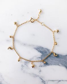 Star moon gold charm bracelet. Perfect for the modern fashionista - Parisian style and glam - Delicate, fine design that is perfect for layering and stacking - Emulate French style chic now - CLICK TO SHOP STAR MOON BRACELET NOW Star And Moon Bracelet Gold, Charms Bracelet Gold, Gold Bracelet With Charms, Braclate Design Gold, Cute Jewelry Bracelets, Delicate Gold Bracelet, Bracelet With Charms, Delicate Jewellery