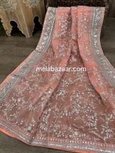 Gorgeous peach organza dupatta with silver embroidery and heavy sequins border. Silver Organza Dupatta In Traditional Drape, Peach Party Dupatta With Zari Work, Peach Dupatta For Party And Festivals, Peach Georgette Dupatta For Festivals, Peach Dupatta With Resham Embroidery In Traditional Drape, Silver Georgette Dupatta In Traditional Drape, Silver Georgette Dupatta For Diwali, Bollywood Style Peach Dupatta With Chikankari Embroidery, Peach Georgette Dupatta For Wedding