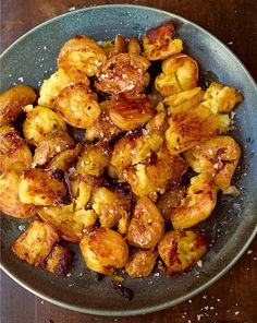 a bowl filled with fried food on top of a wooden table