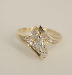 a yellow gold ring with three diamonds on it