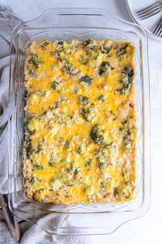 a casserole dish with broccoli and cheese in it on a table