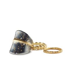 a pair of gold and black rings on a white background with space in the middle