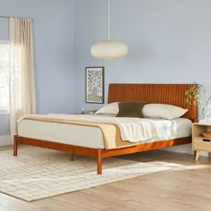 a bed room with a neatly made bed next to a night stand and two nightstands