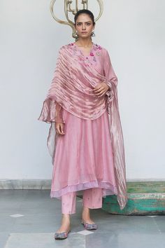 Plum chanderi kurta with 3D organza flowers on the yoke panel in a V-neck. Complemented with a tissue dupatta and hand embroidered pants.
Component: 3
Embroidered
Neckline: V-Neck
Sleeve Length: Three Quarter
Fabric: Kurta: Chanderi; Pant: Cotton; Lining:  Cotton; Dupatta: Tissue
Color: Pink, Purple
A-line silhouette kurta
Attached cotton lining kurta
3D organza tissue flowers, hand embroidery and bullion knots across the yoke
Floral hand embroidered pant
Side slit kurta
Asymmetric hem kurta - A Beige Kurta, Purple Embroidery, Fancy Fits, Kurta Set For Women, Kurti Designs Latest, Kurti Embroidery Design, Fashion Sketches Dresses, Kurta Designs Women, Embroidered Neckline