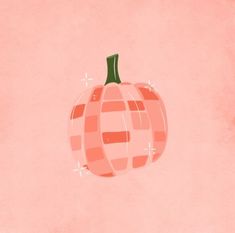 an orange and pink pumpkin sitting on top of a pink wall