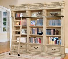 a book shelf with many books on it and a ladder leaning against the wall in front of it