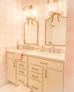 the bathroom is decorated in pink and white checkered wallpaper, with gold accents