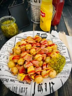 a plate full of food sitting on top of a table next to drinks and condiments