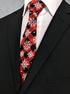 "This mens plaid snowflake necktie features a red and black plaid with allover white snowflake pattern. Pocket Square available upon request pending available of fabric cost $10.00 Convo me to check availability. Expertly hand-made from 100% cotton you can select your length from 57\" to 71\" (Great for taller Men). Width is standard 3.5\" as shown here or skinny 2.5\". If you require a custom length or width, please contact us.  2.5\" x 48\" Child size available upon request.  Ships within 2 business days. Made in the USA. CUSTOM ORDERS We love custom orders, so you can also go to www.Fabric.com to select from one of their thousands of cotton fabrics and we can make a tie or bow tie for you. These requests will take at least 2 weeks to fulfill. Any Questions about this tie, custom orders Fitted Winter Tie, Make A Tie, Christmas Suit, Christmas Ties, Tie Men's, White Snowflake, Mens Plaid, Snowflake Pattern, Christmas Stuff