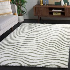 a living room area with a white rug on the floor