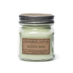 a candle that is sitting on top of a white surface with the label sleigh ride