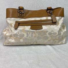 Brand New! Tan Coach Signature C Purse. There Is A Very Light Stain On The Bottom, But It Is Barely Noticeable (See Pictures). Lined Interior Satchel Bag, Elegant Brown Bag With Lined Interior, Beige Leather Bag With Lined Interior, Beige Tote Shoulder Bag With Lined Interior, Elegant Shoulder Bag With Lined Interior, Beige Shoulder Bag For Travel With Lined Interior, Light Stain, Coach Purses, Coach Bags