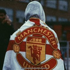 the back of a man in a manchester united jacket