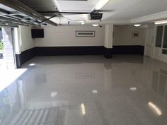 an empty room with white walls and black trim on the floor is seen in this image