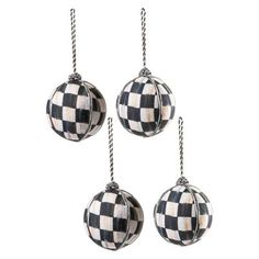 three black and white checkered ornaments hanging from twine chains on a white background