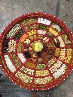 a red basket filled with lots of different types of food on top of a table