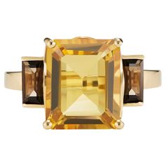 This beautiful 9ct yellow gold ring from the Andalusian Collection features an exquisite octagon-cut yellow citrine flanked by baguette-cut smoky quartz, inspired by the warm golden hues of Seville's palaces. The Andalusian-inspired luxury jewellery London designed collection takes inspiration from Hispano-Moorish architectural styles of the enchanting southernmost region of Spain. The gemstone jewellery from this collection designed by British Jewellers boasts vibrant yet sophisticated combinat Orange Gemstones, Custom Gold Jewelry, Orange Citrine, Yellow Gold Setting, Yellow Citrine, Citrine Ring, Peridot Gemstone, Citrine Gemstone, Gold Colour