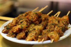 a white plate topped with meat and toothpicks