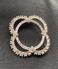 "This beautiful vintage Bogoff clear rhinestone brooch is so pretty; delicate, elegant design which can be worn for many occasions. Henry Bogoff's jewelry had a reputation for high quality jewelry and each piece was made by hand and had a lifetime warranty. The company invented many ways to create individual elements of jewelry, as well as the designs of jewelry, and in the mid-40s-50s, the company patented their creations. All products of the company had marks \"Bogoff\", and after the 1955 app Anniversary Costume Jewelry Brooches With Rhinestones, Formal Rhinestone Costume Brooches, Anniversary Rhinestone Costume Brooches, Vintage Diamond Round Brooches, Formal Costume Jewelry Brooches With Sparkling Stones, Elegant Round Brooches With Rhinestones, Elegant Silver Sparkling Brooches, Elegant Round Rhinestone Brooches, Vintage Diamond White Brooches For Formal Occasions