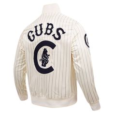 Add a throwback finish to any look with this Chicago Cubs Classic full-snap jacket from Pro Standard. It features retro team graphics over an eye-catching pinstripe pattern. The satin fabric adds a sleek finish to this must-have Chicago Cubs jacket. Heat-sealed chenille applique with raised embroidered details Full Snap Officially licensed Long sleeve Stand-up collar Material: 100% Polyester Machine wash, tumble dry low Midweight jacket suitable for moderate temperatures One interior pocket Two Collegiate Style Long Sleeve Track Jacket For Sports Events, White Track Jacket For Fall Sports Events, Casual Streetwear Outerwear With Signature Stripes, Casual Outerwear With Signature Stripes For Streetwear, Collegiate Long Sleeve Track Jacket For Sports Events, Retro Crew Neck Outerwear With Ribbed Cuffs, Throwback Long Sleeve Outerwear For Game Day, Throwback Sports Outerwear With Baseball Collar, Retro Crew Neck Outerwear For College