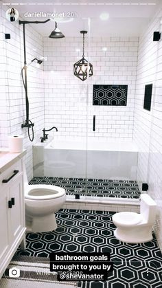 a bathroom with black and white tiles on the floor