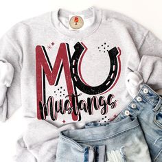 a sweatshirt with the word mo mustangs on it next to some shorts and shoes