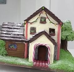 a cake shaped like a house on top of a table