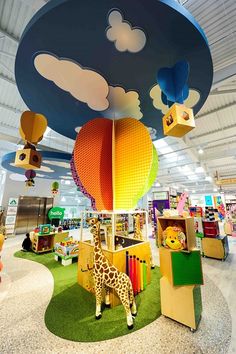 the children's playroom is filled with toys and stuffed giraffes