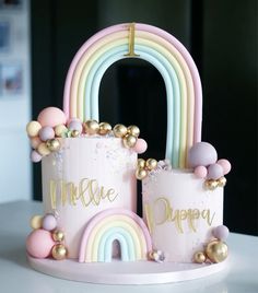 there is a pink cake with gold decorations and a rainbow on the top that says memee dupre