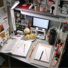 the desk is cluttered with pens, notebooks and other office supplies on it