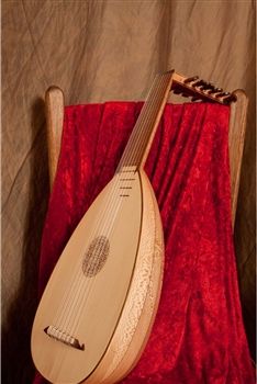 a wooden instrument sitting on top of a red blanket