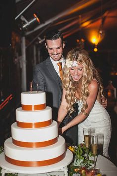 a newly married couple cutting their wedding cake