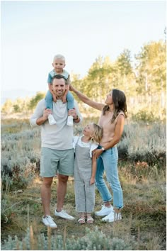 a family is posing for a photo in the field