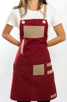 a woman is wearing an apron and has her hands on her hips as she stands in front of a white background