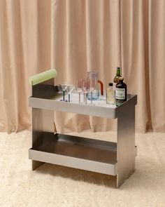 a metal table with wine glasses and bottles on it