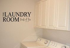 the laundry room wall decal is shown in black on a white washer and dryer