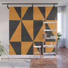 an orange and black geometric wall mural in a living room