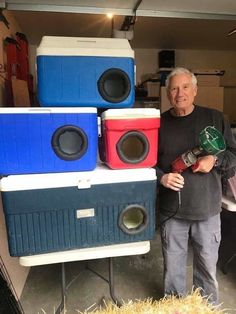 a man standing next to some speakers in a garage