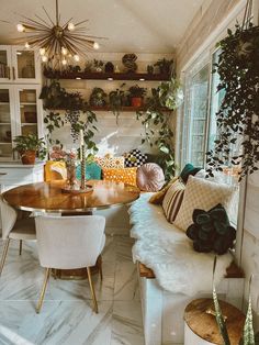 a living room filled with furniture and lots of plants