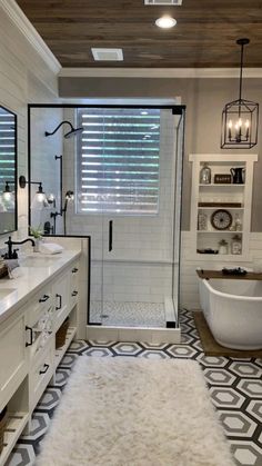 a bathroom with a tub, sink, and shower stall in it's center