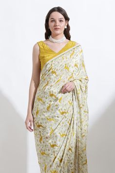 Yellow, cream and beige saree with all over floral and reindeer print, highlighted with pearls. Comes along with an unstitched blouse fabric.
Components: 2
Pattern: Print
Type Of Work: Reindeer
Fabric: Crepe
Color: Yellow,Beige,Cream
Other Details: 
Note: Stitched blouse worn by the model is not for sale
Occasion: Mehendi and Haldi - Aza Fashions Unstitched Elegant Kalamkari Blouse Piece, Elegant Kalamkari Print Blouse Piece For Festive Season, Elegant Traditional Wear With Kalamkari Print, Festive Cream Silk Blouse Piece, Festive White Kalamkari Print Blouse Piece, Cream Self-design Saree, Elegant Blouse Piece With Printed Motifs For Navratri, Festive White Blouse With Kalamkari Print, Elegant Silk Blouse With Kalamkari Print