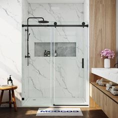 a bathroom with marble walls and flooring next to a bathtub that has a glass shower door