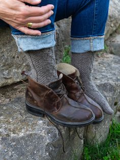 This top-down, richly-textured sock in two sizes S(L) is a gorgeous accessory for men and women alike. Worked in a warm, wooly yarn it is a hiking/rowing/snowshoeing essential; in sleek, smooth yarn it is a stylish accent to casual suits or slacks. With cabled details on all sides and cushy moss stitch panels, it is fun to work and a small project to be proud of—plus, a gift that says you think the most of a special someone. Shown here is size S in Border Leicester Fingering, color Rainbow GrayS Cozy Outdoor Socks For Fall, Casual Hiking Socks For Winter, Casual Winter Hiking Socks, Casual Knit Winter Socks, Casual Brown Outdoor Socks, Casual Brown Socks For Outdoor, Winter Outdoor Brown Socks, Brown Winter Outdoor Socks, Casual Hand Knitted Socks