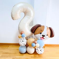 a balloon shaped like a dog holding balloons