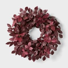 a wreath with red leaves hanging from it